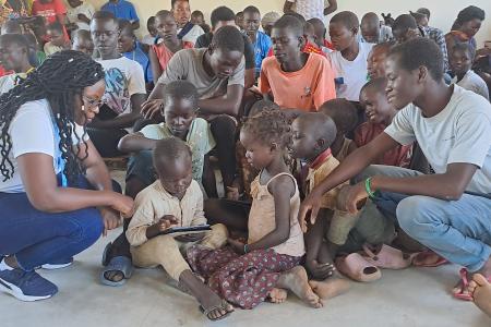 children during a digital literacy class in Imvepi Refugee Settlement