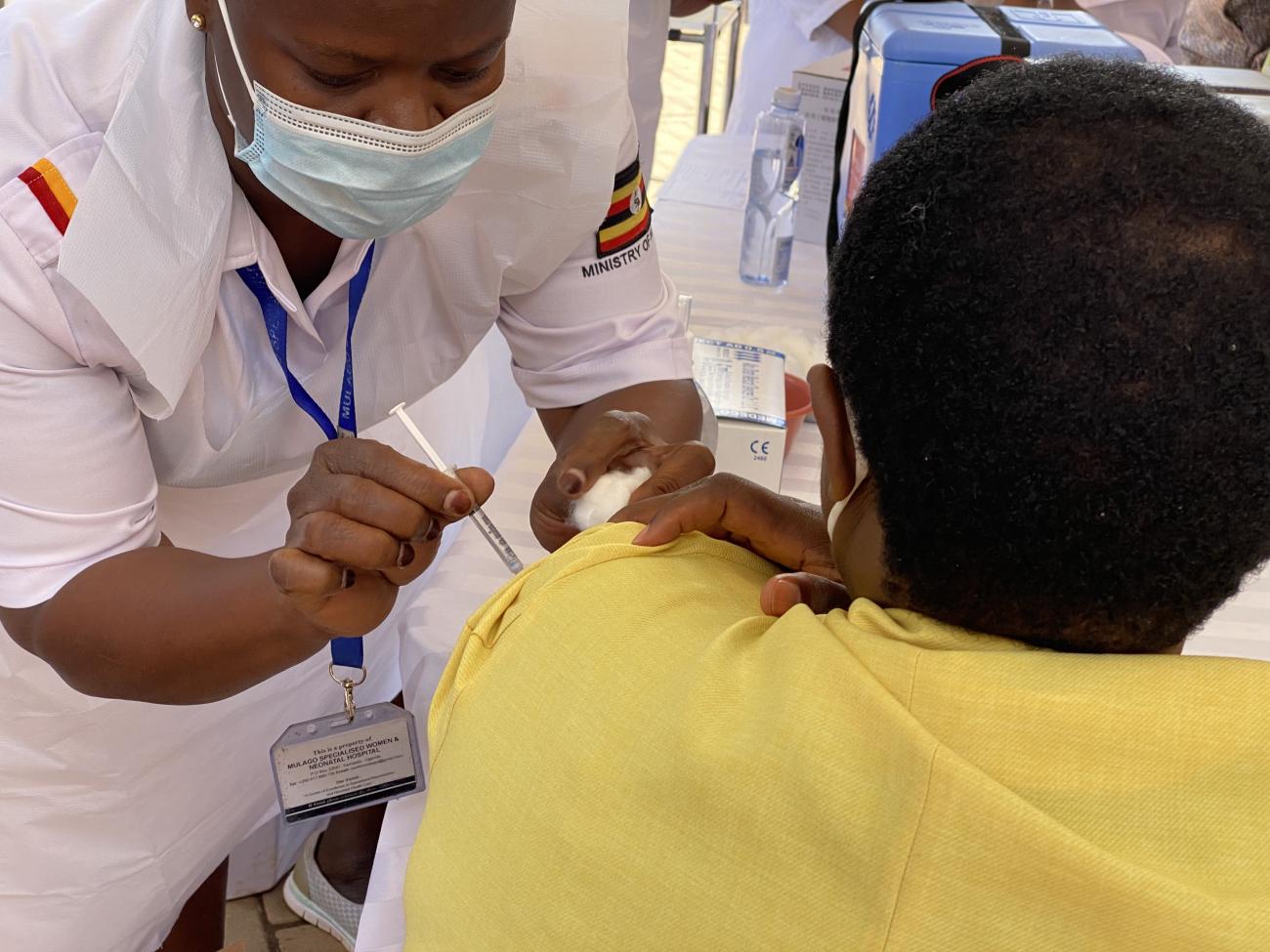 A health worker administers the COVID-19 vaccine in Uganda
