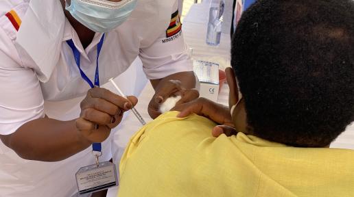 A health worker administers the COVID-19 vaccine in Uganda